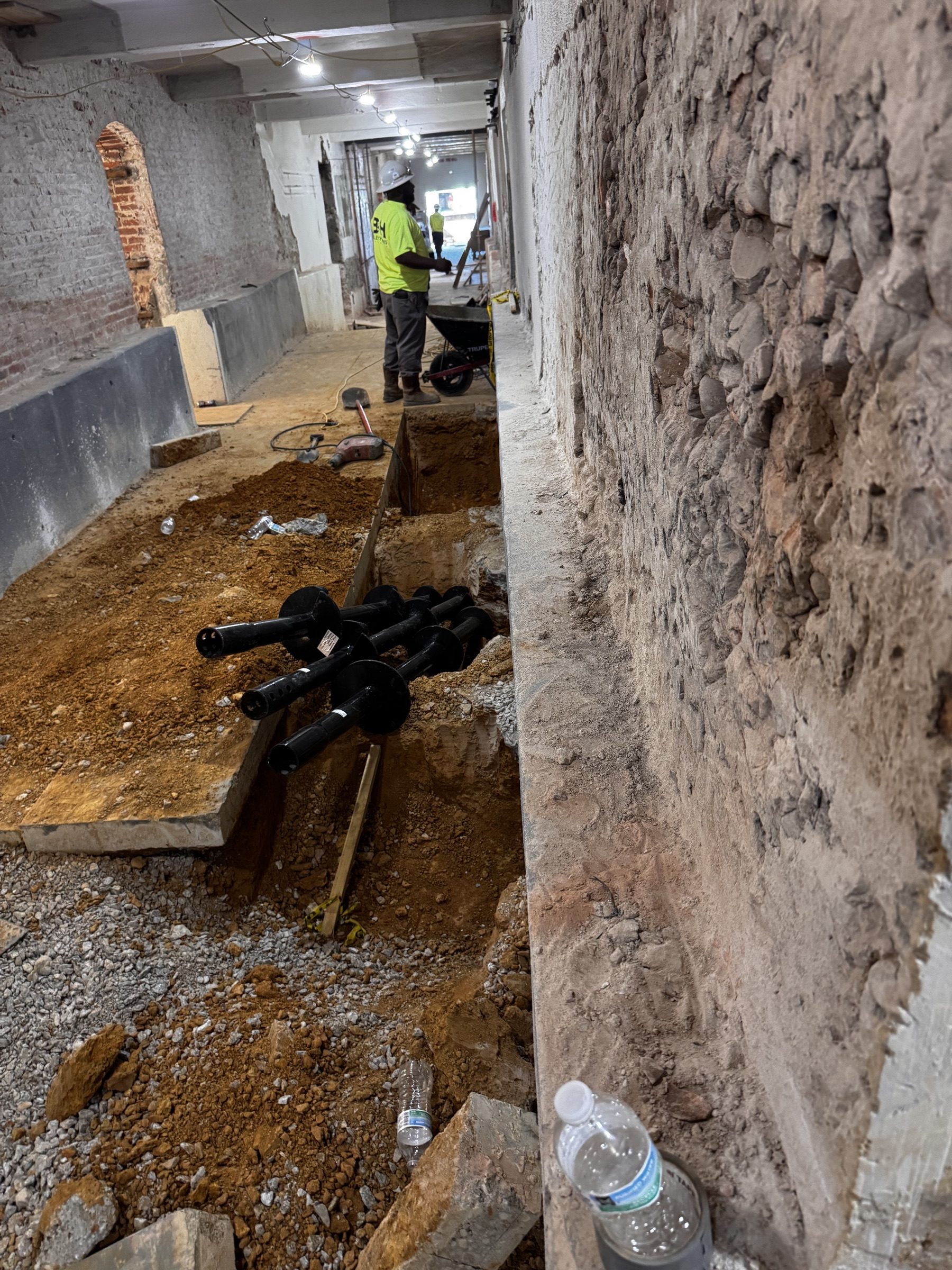 Helical pile sections and helix plates staged on site