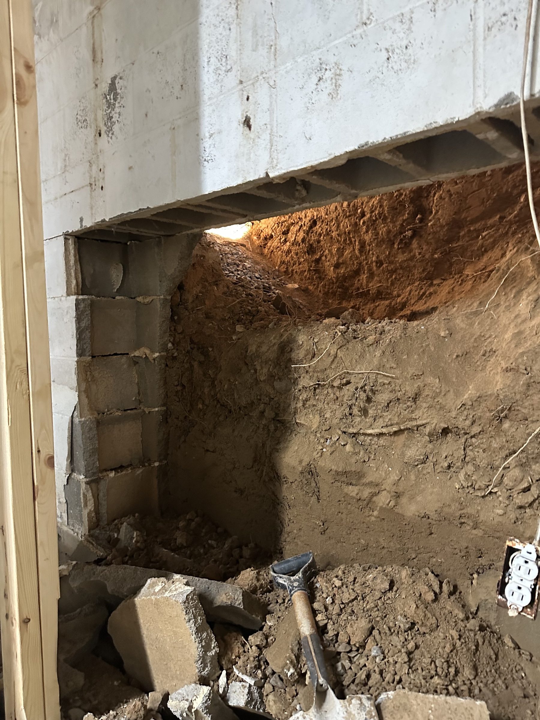 Excavation exposing an undermined footing