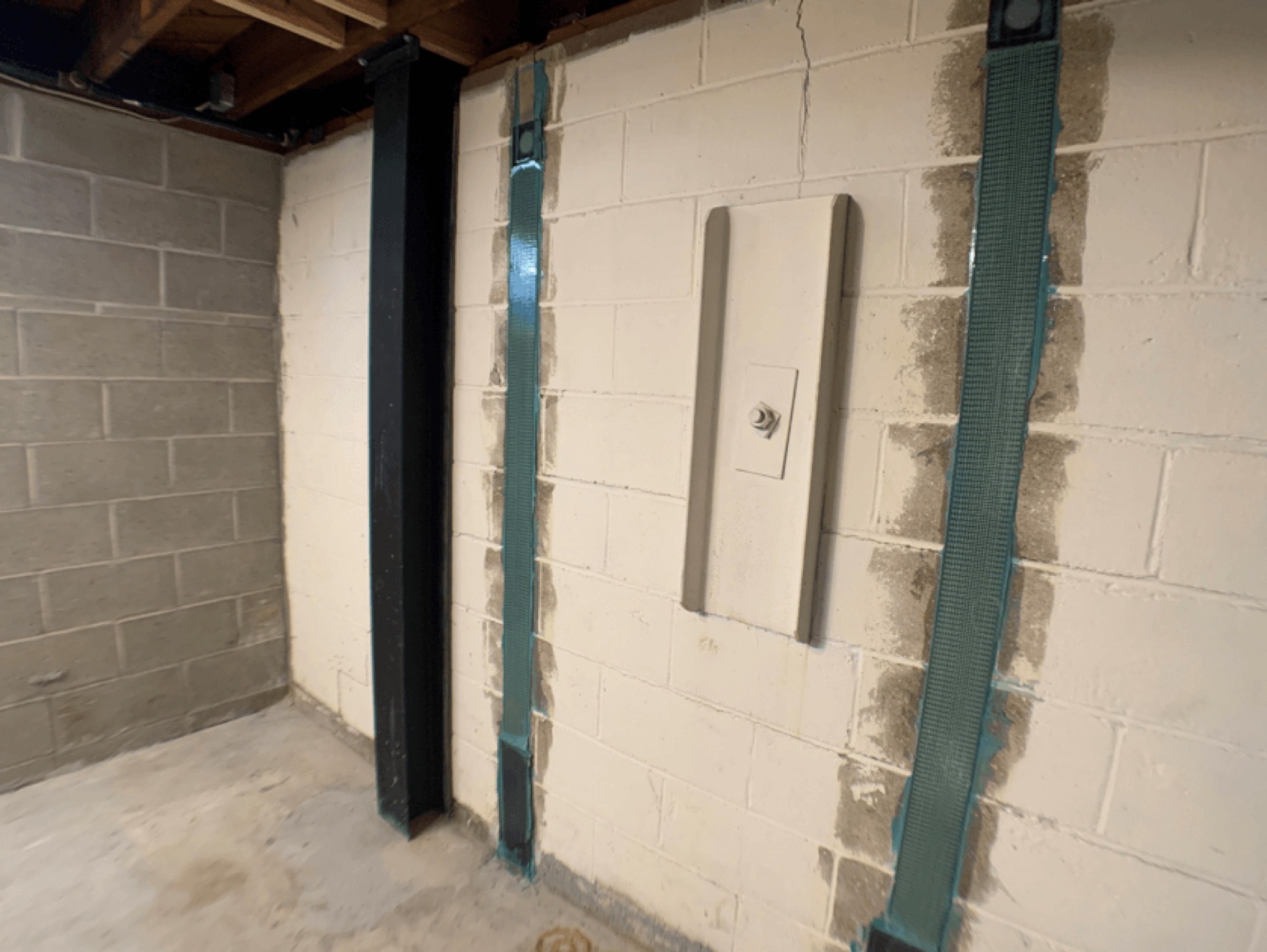 Strap bracing fixed to a block basement wall